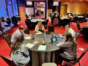 Photo of a group in discussion at POWRR workshop