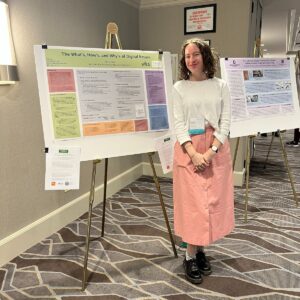 Kelsie Flack beside her poster presentation at the Midwest Archives Conference in Chicago in April 2023