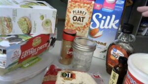 A photo of various food items, including almond milk, oat milk, and cottage cheese