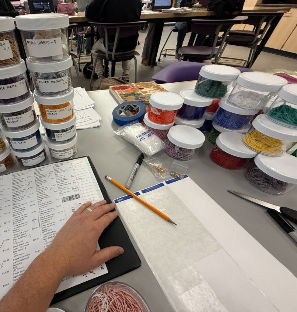 stacks of clear round containers that hold size 11 Czech seed beads, thread and various types of needles.