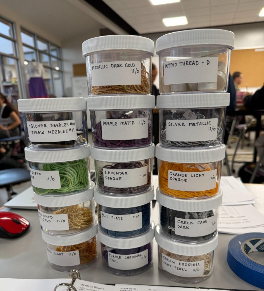 stacks of clear round containers that hold size 11 Czech seed beads, thread and various types of needles.